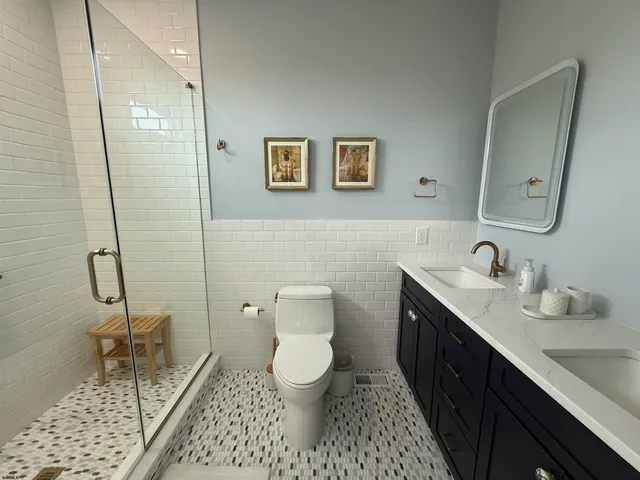 a bathroom with a toilet a sink and mirror