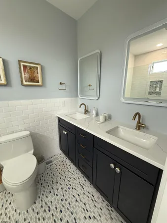 a bathroom with a toilet sink and mirror