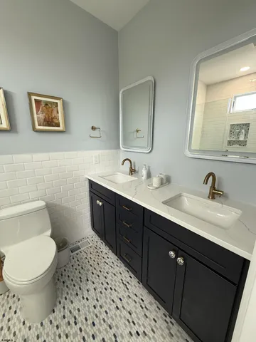 a bathroom with a toilet sink and mirror