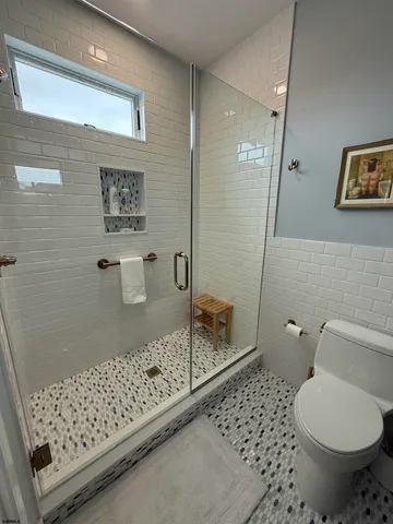 a bathroom with a toilet and a shower
