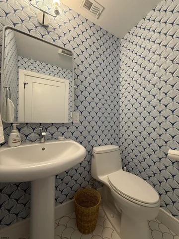 a bathroom with a sink toilet and mirror