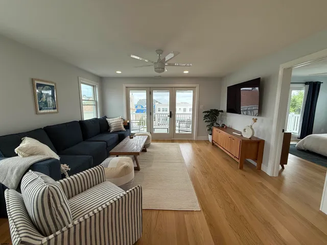 a living room with furniture fireplace and a flat screen tv