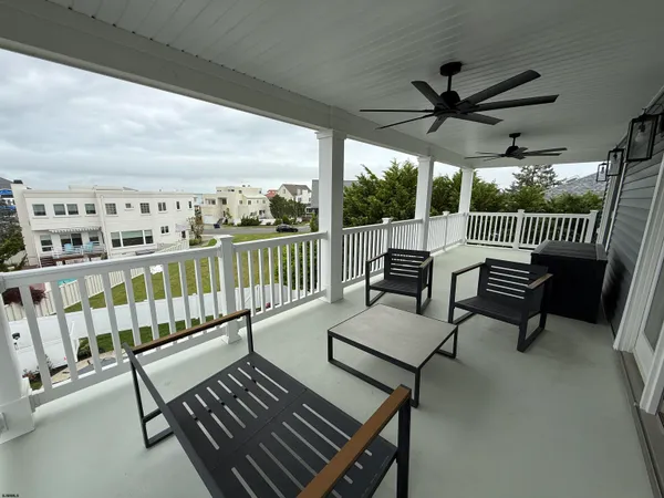 a balcony with wooden floor outdoor seating and city view