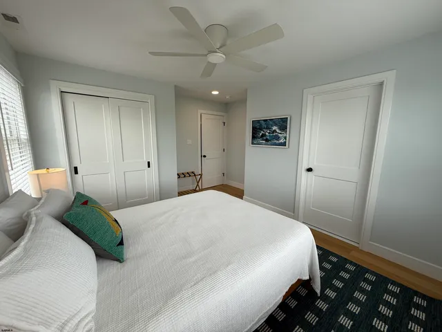 a bedroom with a large bed and a chandelier