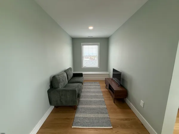 a living room with furniture and a rug