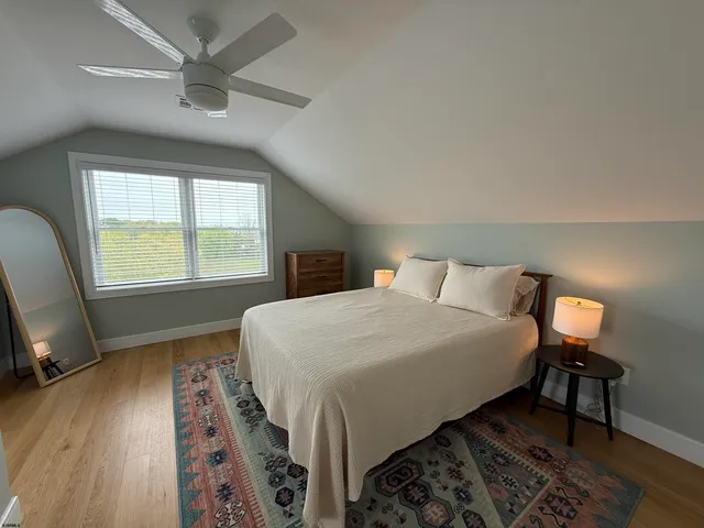 a bedroom with a large bed and a window