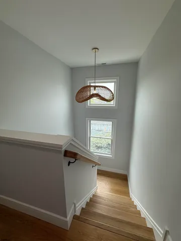 a view of room with stairs and wooden floor
