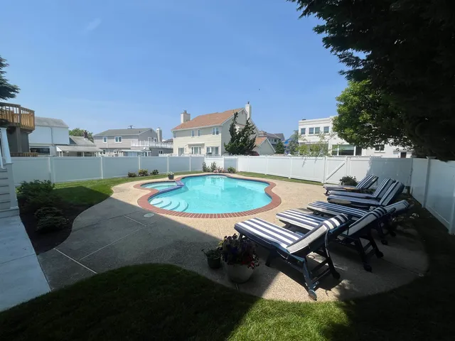 a view of a swimming pool with lounge chair