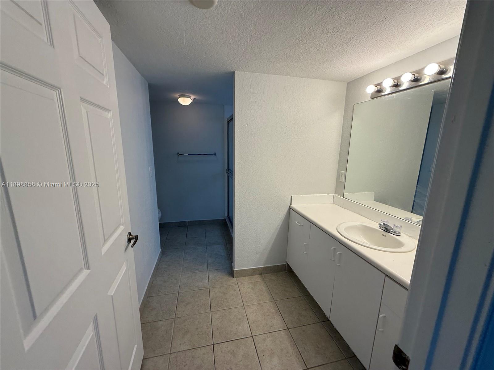 3452 Cypress Trail, Unit 101 West Palm Beach, FL 33417 - Photo 18 of 29 a bathroom with a sink toilet and shower