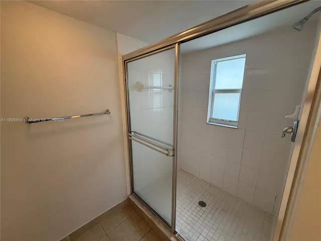 a bathroom with a glass shower door