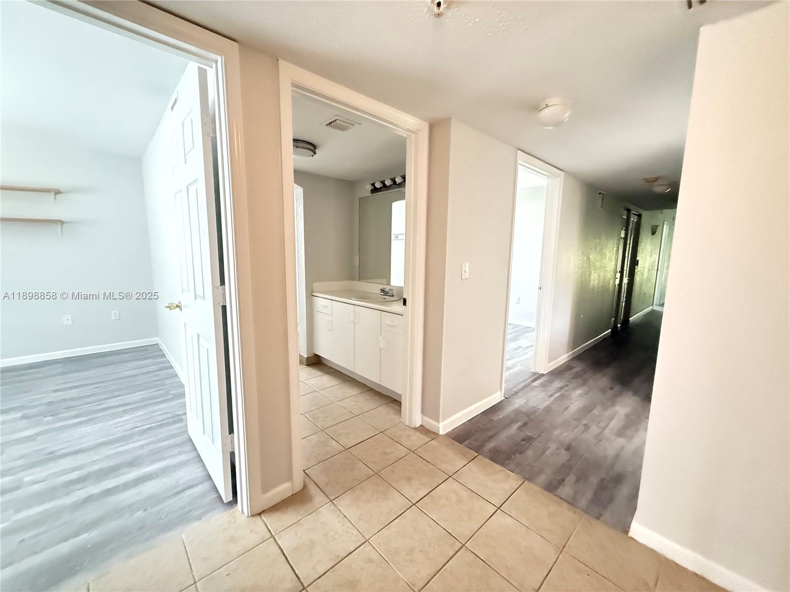3452 Cypress Trail, Unit 101 West Palm Beach, FL 33417 - Photo 25 of 29 a view of a hallway with wooden floor and staircase