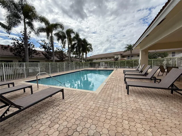 a park view with a bench and lake view