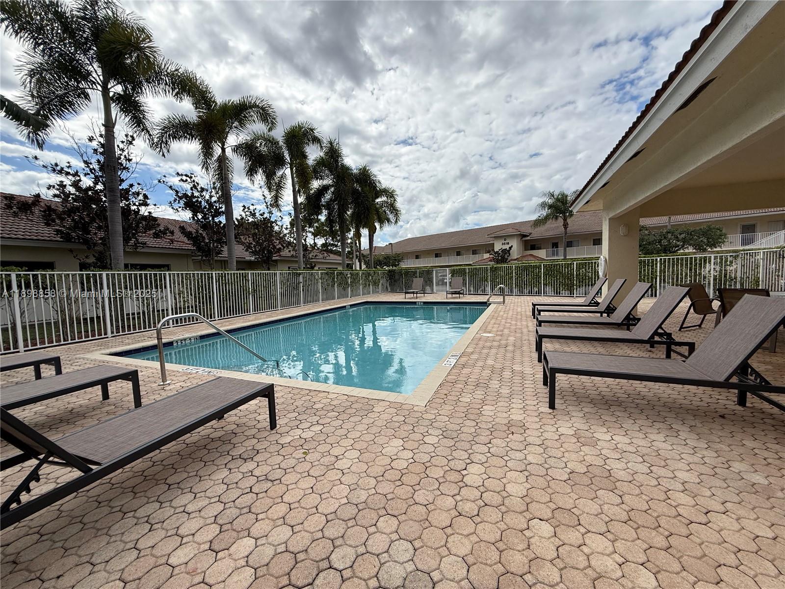 3452 Cypress Trail, Unit 101 West Palm Beach, FL 33417 - Photo 28 of 29 a park view with a bench and lake view