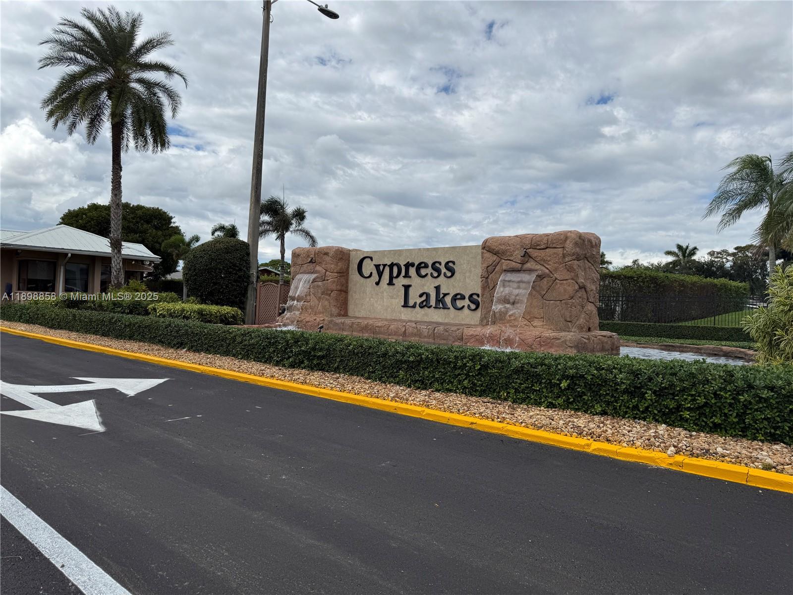 3452 Cypress Trail, Unit 101 West Palm Beach, FL 33417 - Photo 29 of 29 a front view of a house with swimming pool and ocean view