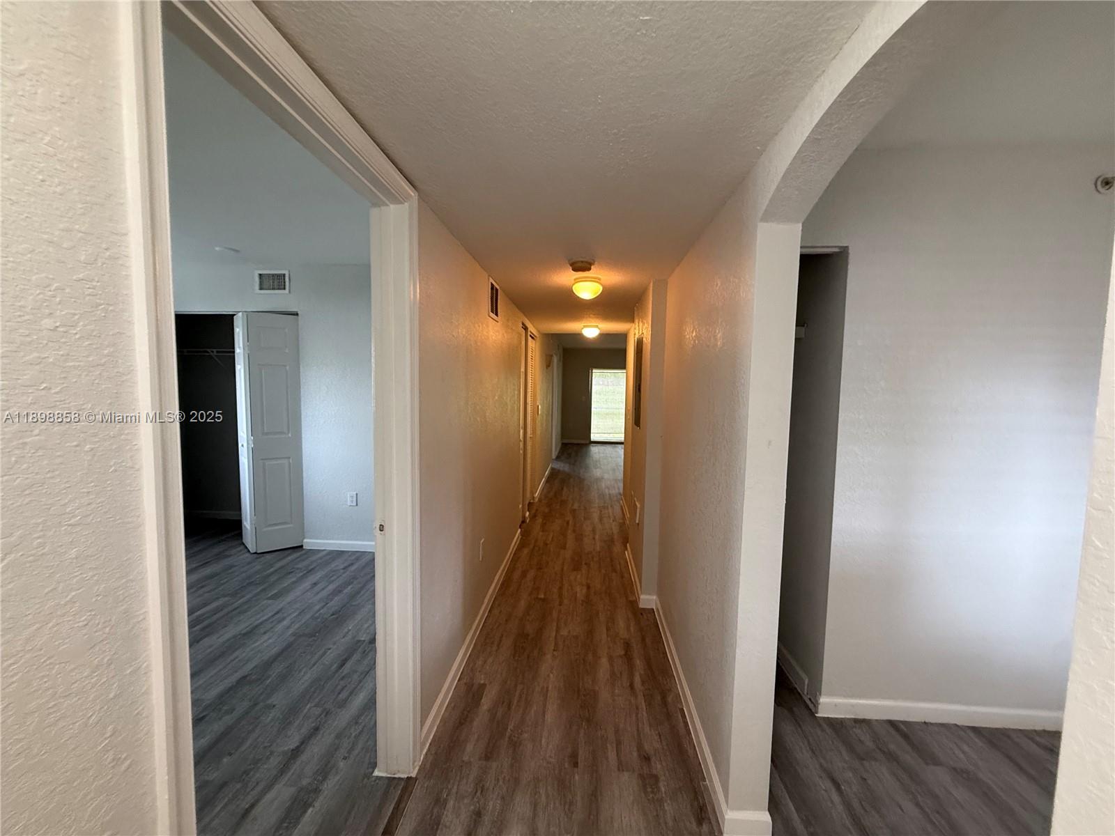 3452 Cypress Trail, Unit 101 West Palm Beach, FL 33417 - Photo 5 of 29 a view of hallway with wooden floor