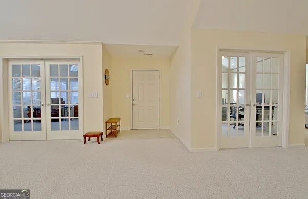 a living room with furniture a flat screen tv and a window