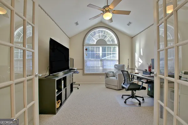 a dining room with furniture a chandelier and a window