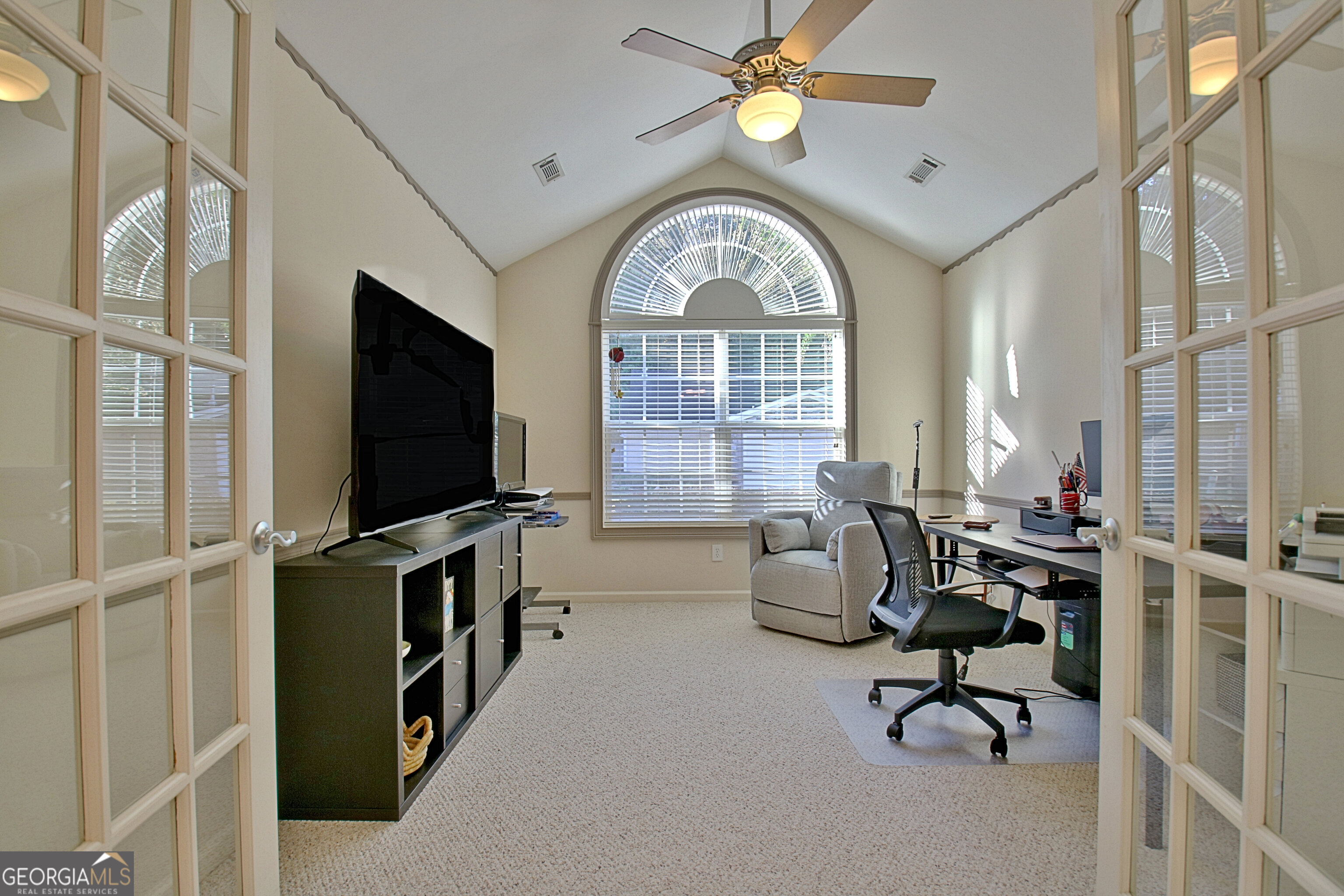 265 Rehobeth Way Fayetteville, GA 30214 - Photo 16 of 63 a living room with furniture a flat screen tv and a window