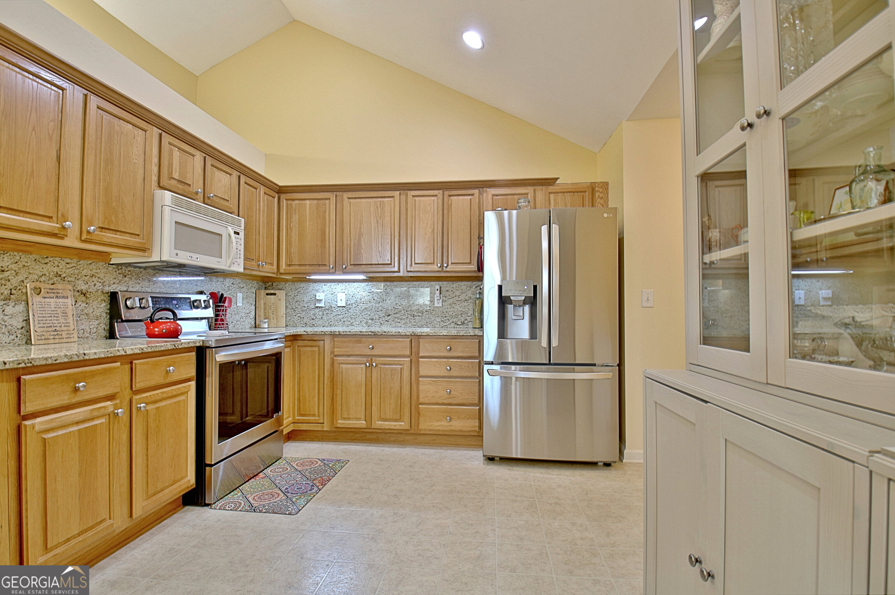 265 Rehobeth Way Fayetteville, GA 30214 - Photo 22 of 63 a kitchen with stainless steel appliances granite countertop a refrigerator sink and cabinets