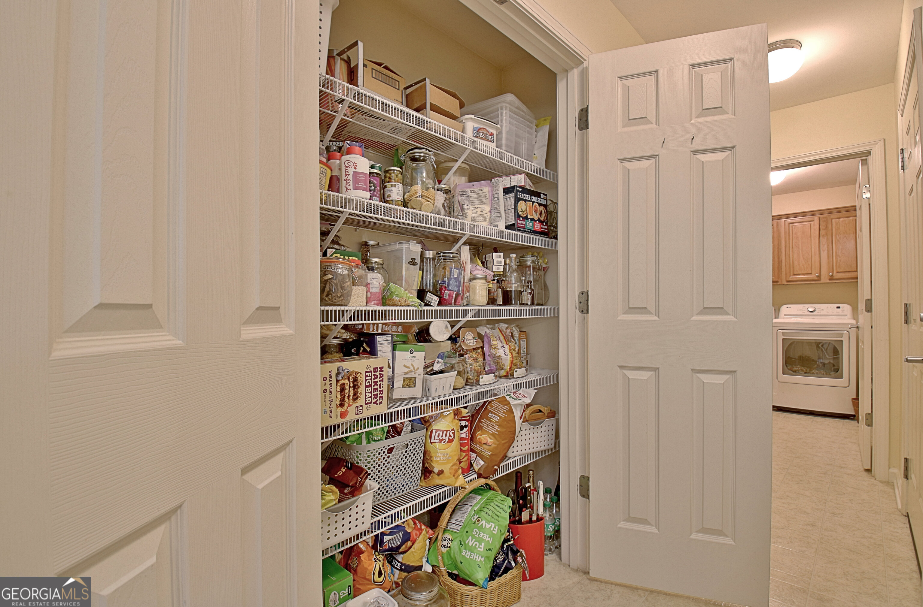 265 Rehobeth Way Fayetteville, GA 30214 - Photo 27 of 63 a view of walk in closet with clothes and shoes