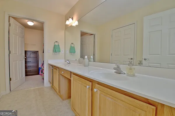 a bathroom with a double vanity sink and mirror