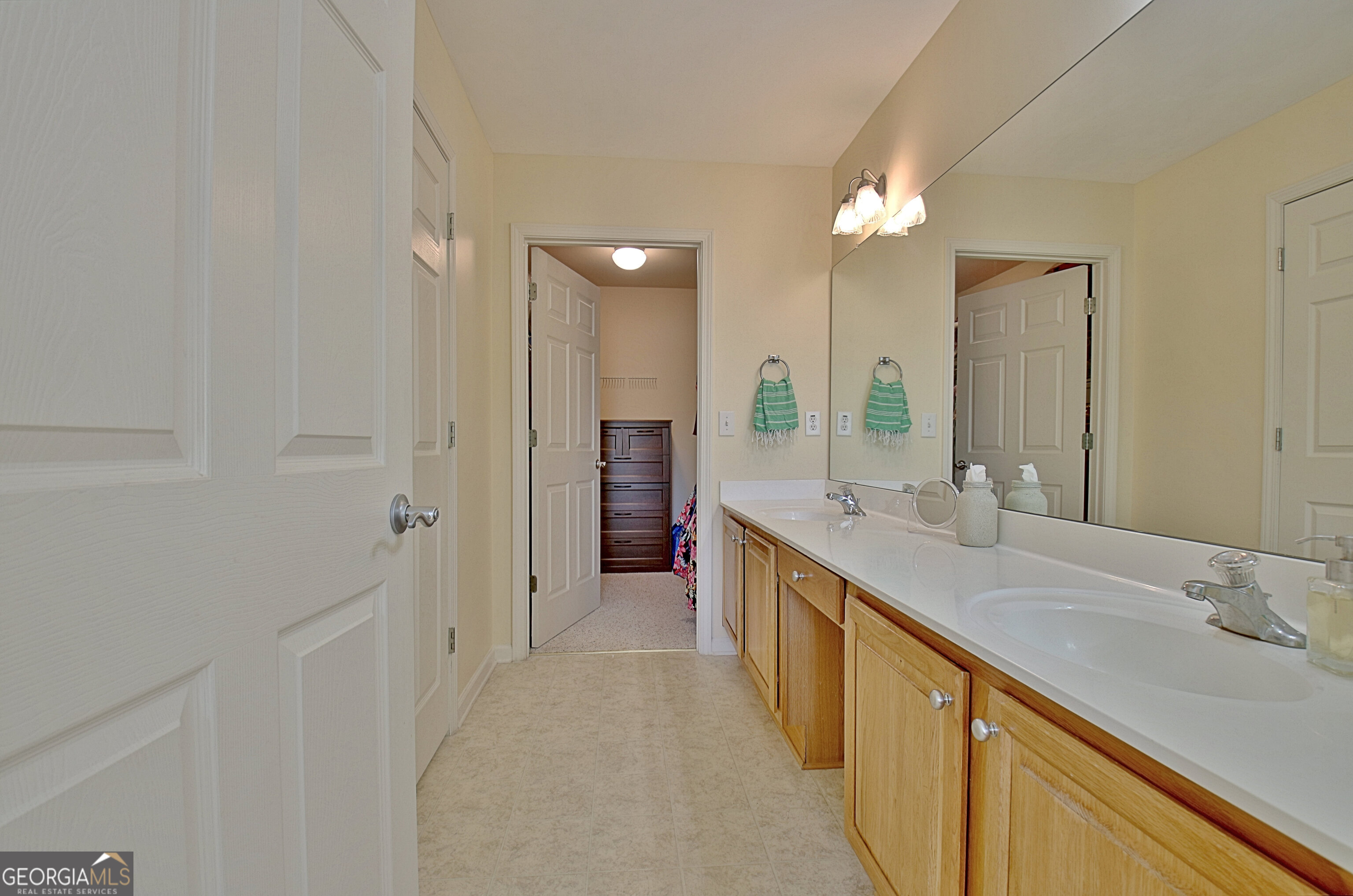 265 Rehobeth Way Fayetteville, GA 30214 - Photo 40 of 63 a large bathroom with a double vanity sink a large mirror and a shower