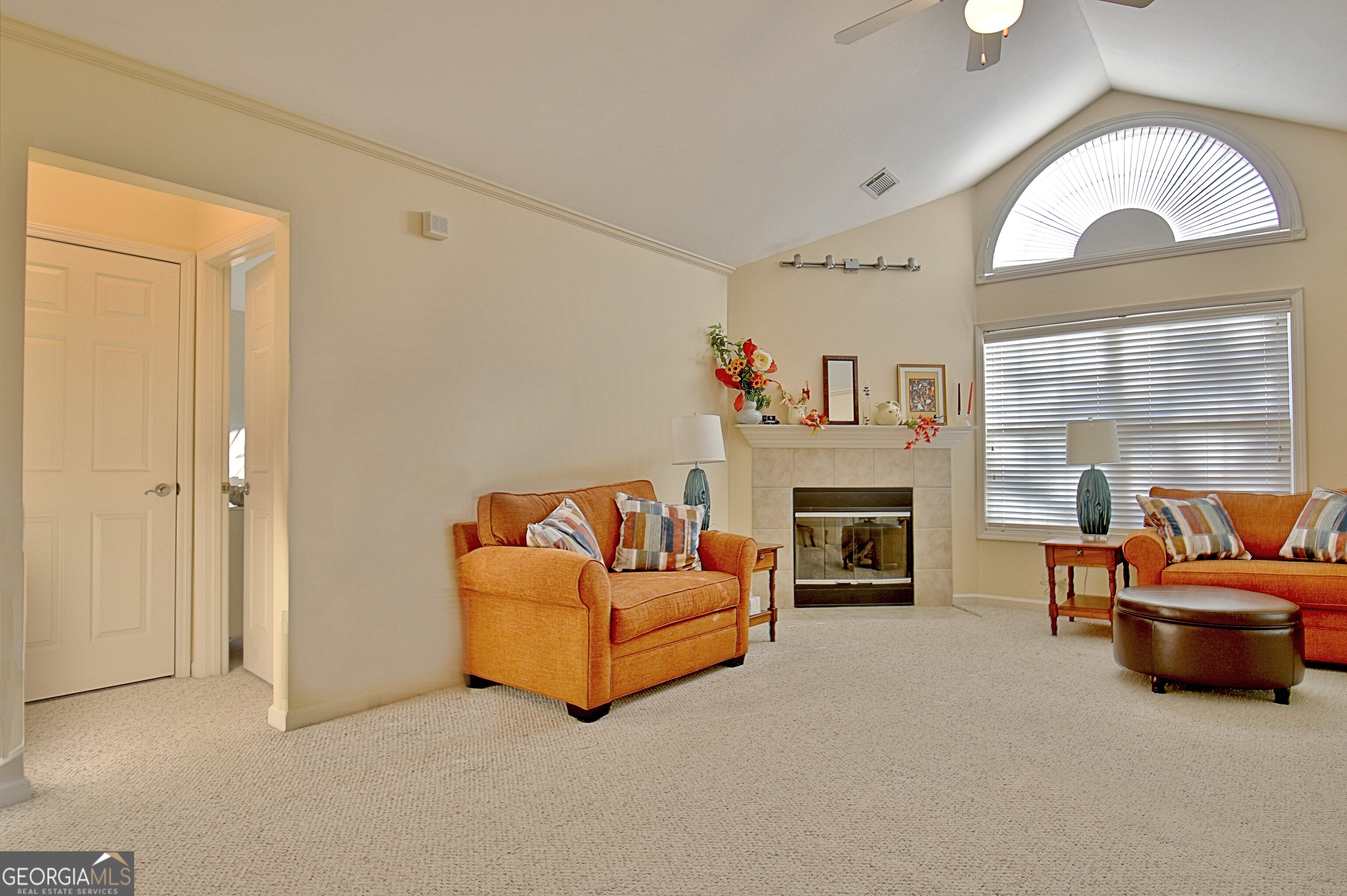 265 Rehobeth Way Fayetteville, GA 30214 - Photo 4 of 63 a living room with furniture a fireplace and a large mirror