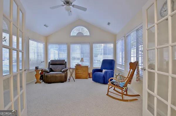 a living room with furniture a fireplace and a large window