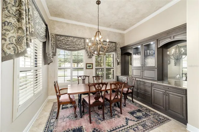 a bathroom with a sink a large mirror and a clock on the wall