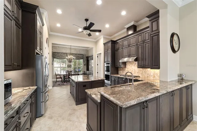 a spacious bedroom with a large bed a flat tv screen and dresser