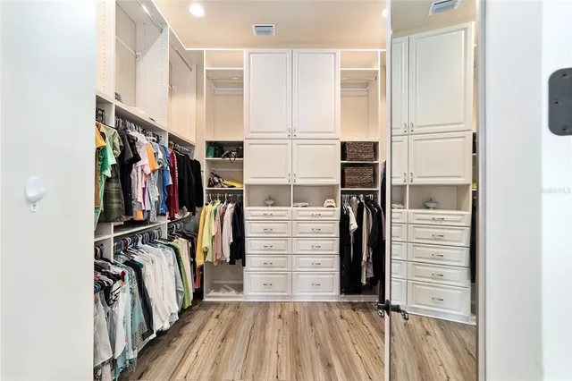 a view of walk in closet with empty racks