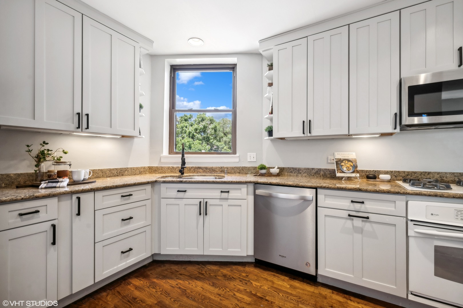 1050 West Byron Street, Unit 3W Chicago, IL 60613 - Photo 12 of 23 a kitchen with white cabinets and white appliances