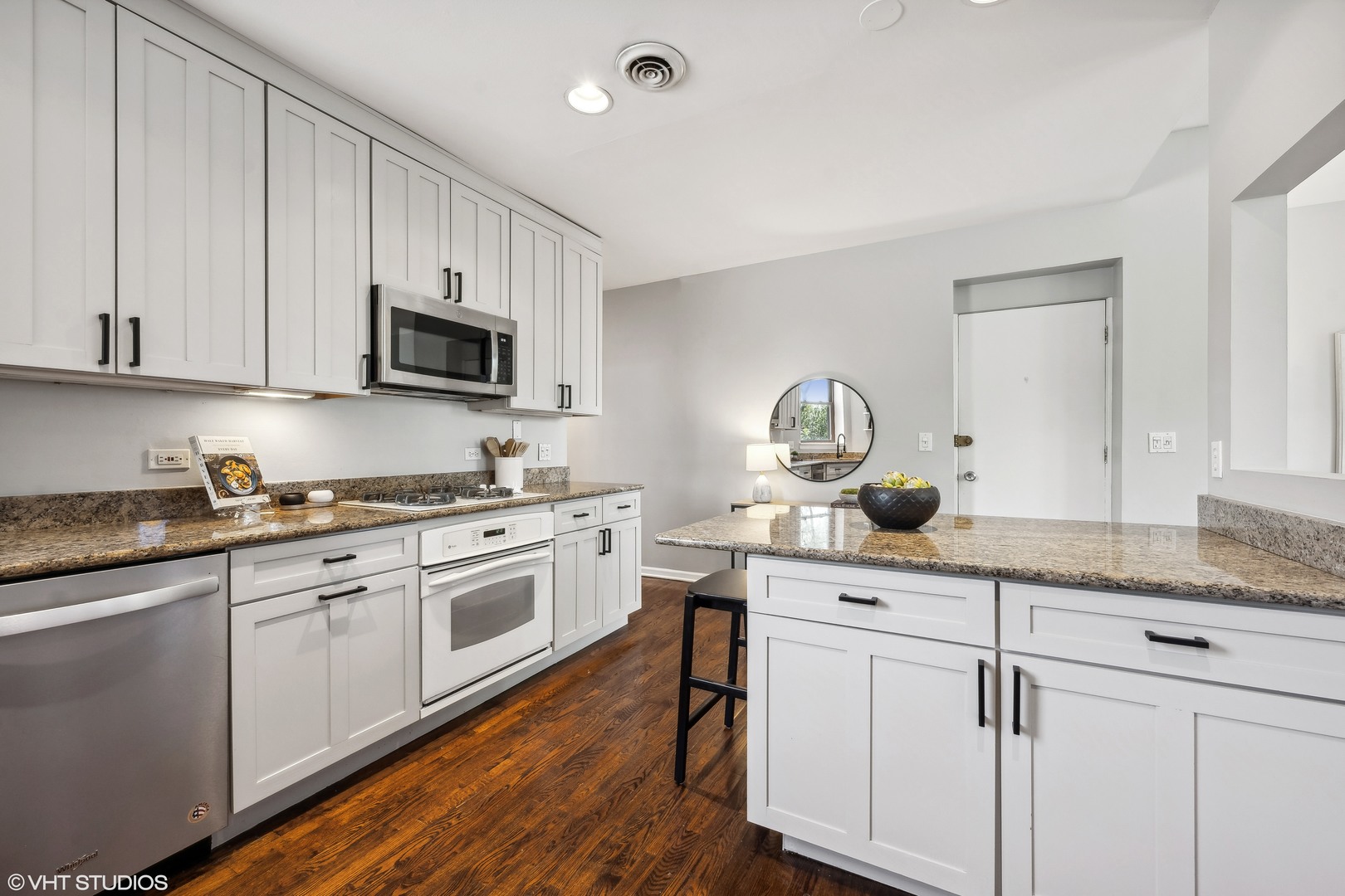 1050 West Byron Street, Unit 3W Chicago, IL 60613 - Photo 13 of 23 a kitchen with granite countertop white cabinets and white appliances
