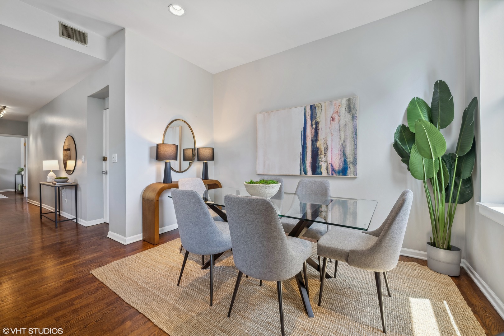 1050 West Byron Street, Unit 3W Chicago, IL 60613 - Photo 8 of 23 a view of a dining room with furniture and a potted plant