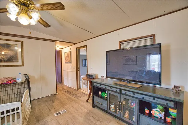 a view of kitchen with stainless steel appliances granite countertop living room