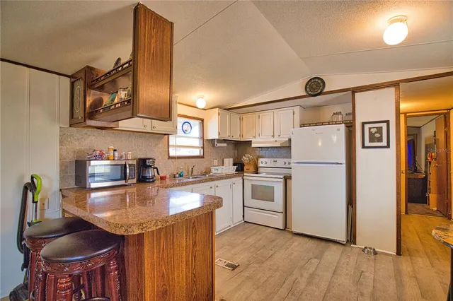 a kitchen with appliances a sink and cabinets