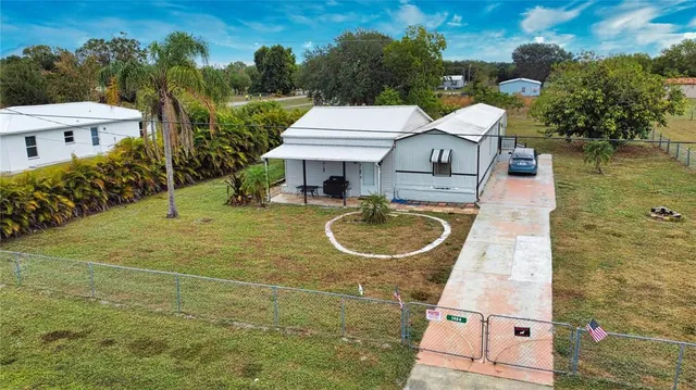 a view of a house with a backyard