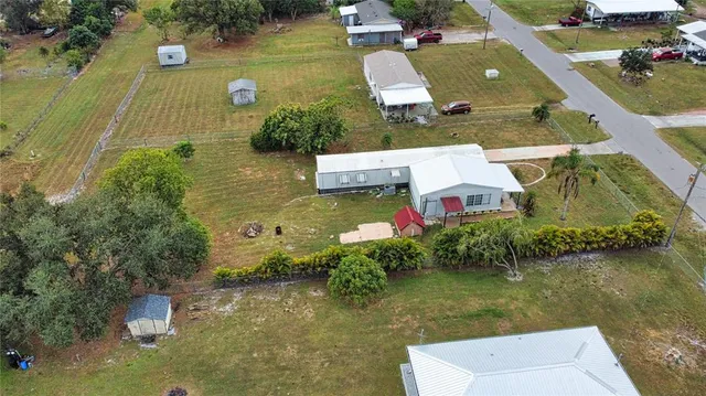an aerial view of house with yard swimming pool and outdoor seating