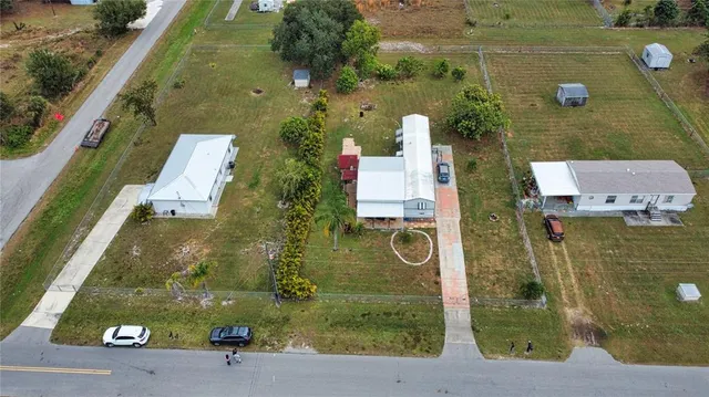 an aerial view of a house with a yard