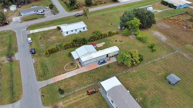 an aerial view of a house with a yard