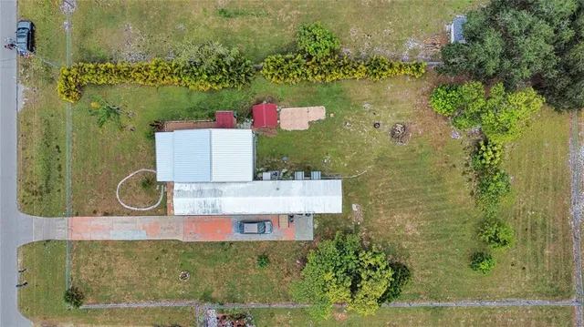 an aerial view of residential houses with outdoor space and swimming pool