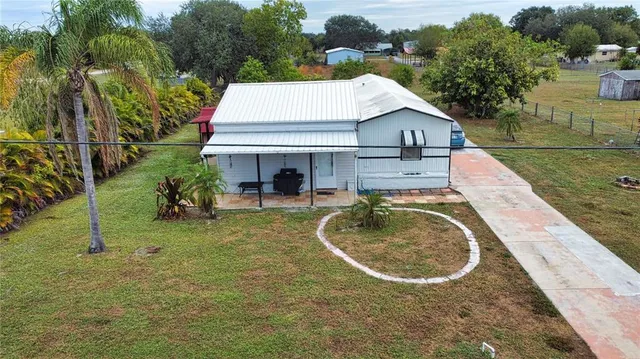 an aerial view of a house with swimming pool and garden