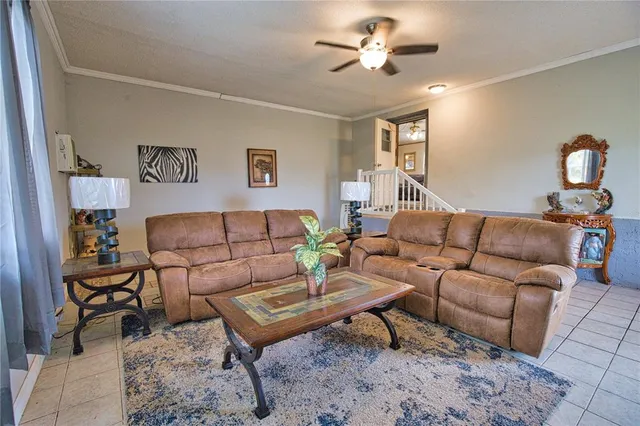 a living room with furniture a rug and a window