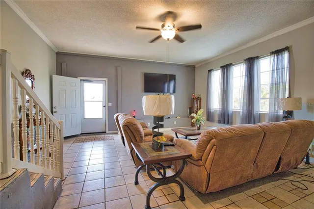 a living room with furniture a chandelier and a window