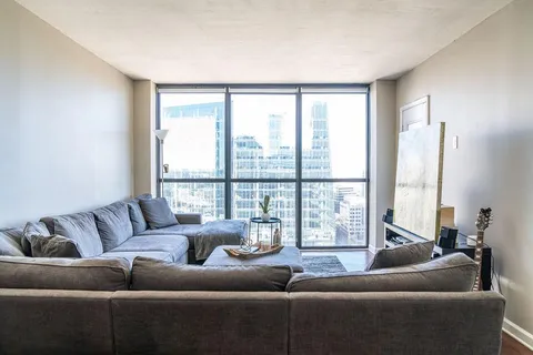 a living room with furniture and a large window