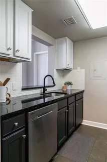a kitchen with stainless steel appliances granite countertop a stove and a refrigerator