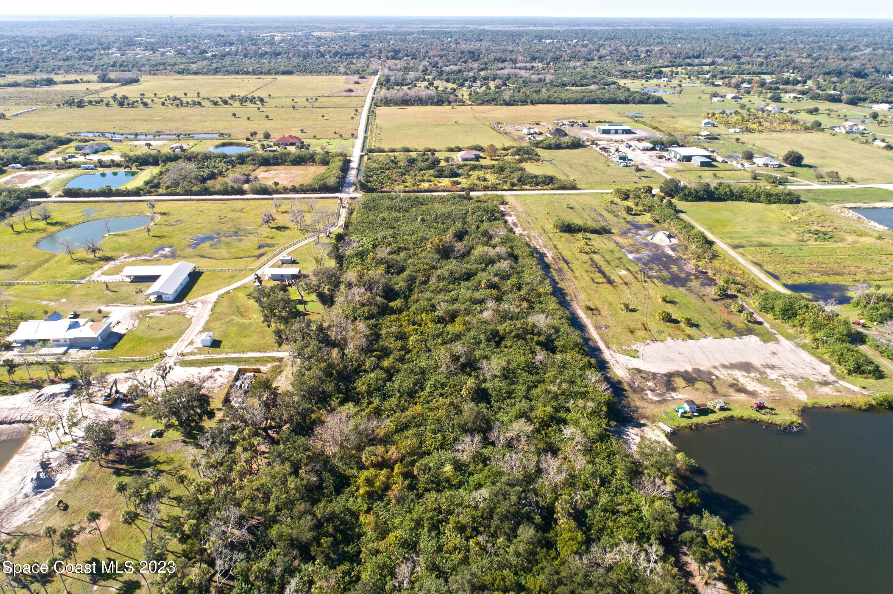 3495 Hammock Road Mims, FL 32754 - Photo 14 of 20 an aerial view of residential building and lake view