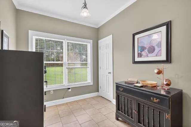 a kitchen with stainless steel appliances granite countertop a stove top oven a sink a dining table and chairs