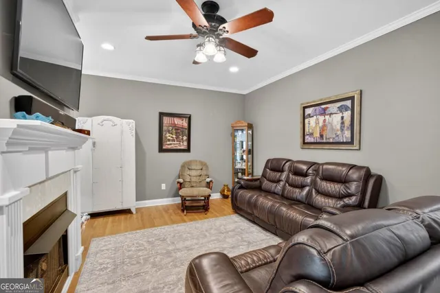 a living room with furniture a flat screen tv and a fireplace