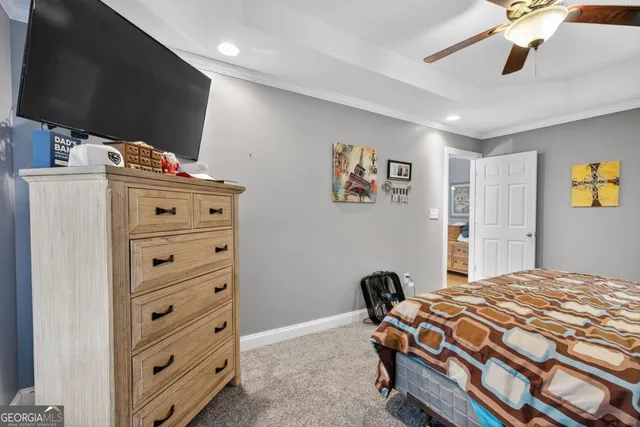 a bedroom with furniture and a flat screen tv